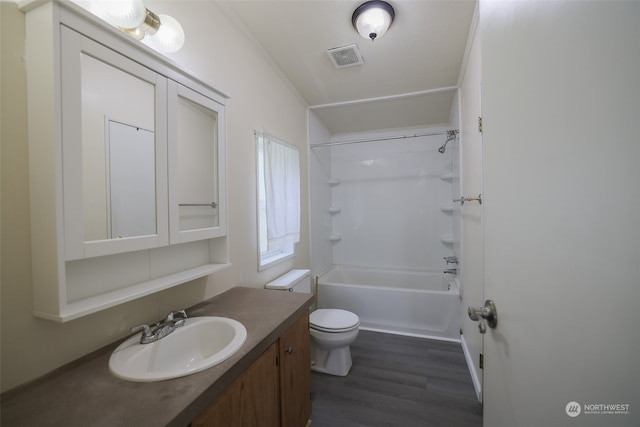 full bathroom featuring vanity, shower / tub combination, crown molding, toilet, and wood-type flooring