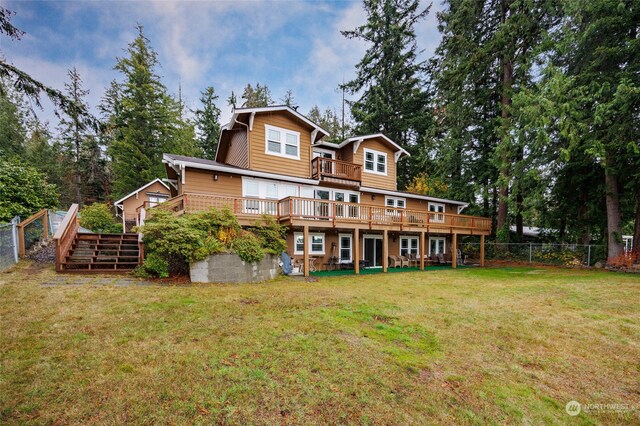 back of house with a lawn and a deck