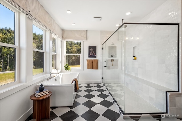 bathroom featuring a healthy amount of sunlight and plus walk in shower