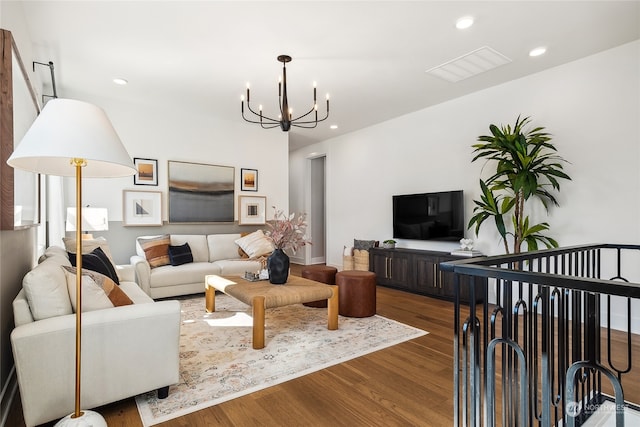 living room featuring a notable chandelier and wood-type flooring