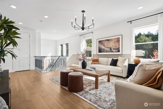 living room with a chandelier and light hardwood / wood-style flooring