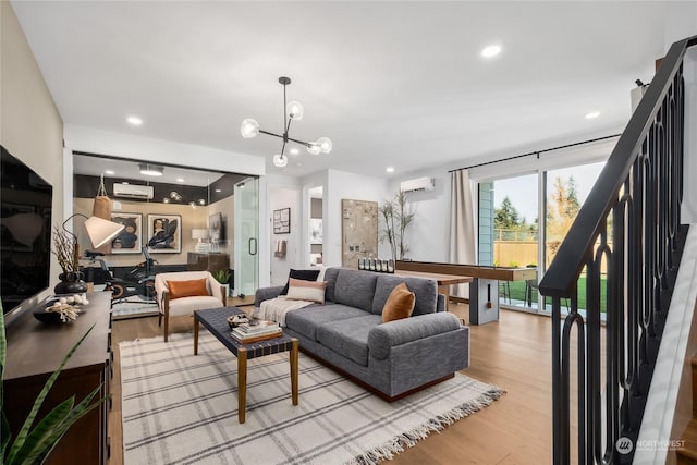 13730 SE 84th St Unit 13, Newcastle, WA 98059 - living area with a wall mounted AC, light wood-style flooring, a chandelier, recessed lighting, and stairs