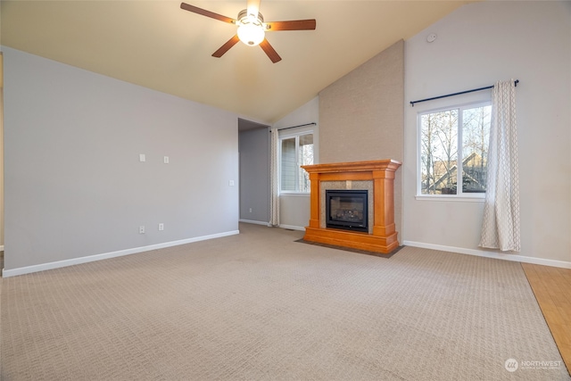 unfurnished living room with hardwood / wood-style floors, ceiling fan, and high vaulted ceiling