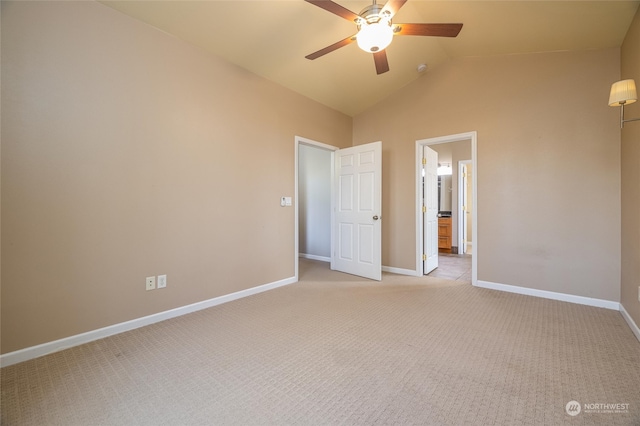 carpeted empty room with ceiling fan and vaulted ceiling