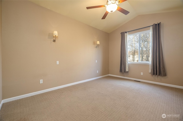 spare room with ceiling fan, carpet floors, and vaulted ceiling