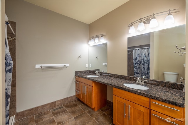 bathroom featuring vanity, toilet, and walk in shower