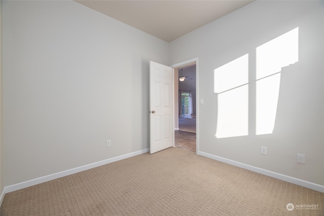 empty room with light carpet and ceiling fan