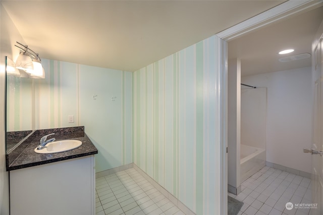 bathroom featuring tile patterned floors, vanity, and bathtub / shower combination