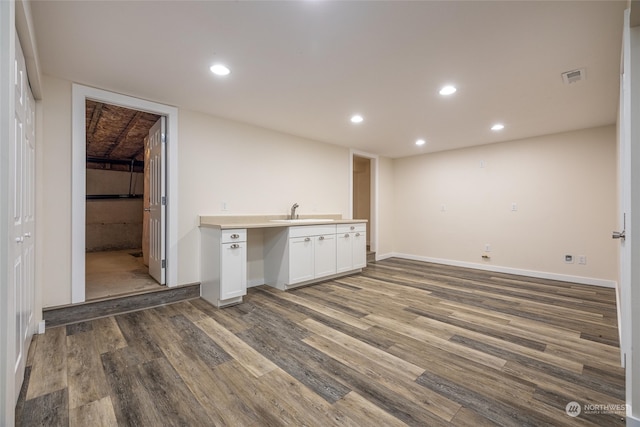 basement featuring dark hardwood / wood-style floors and sink