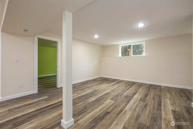 basement with dark hardwood / wood-style floors