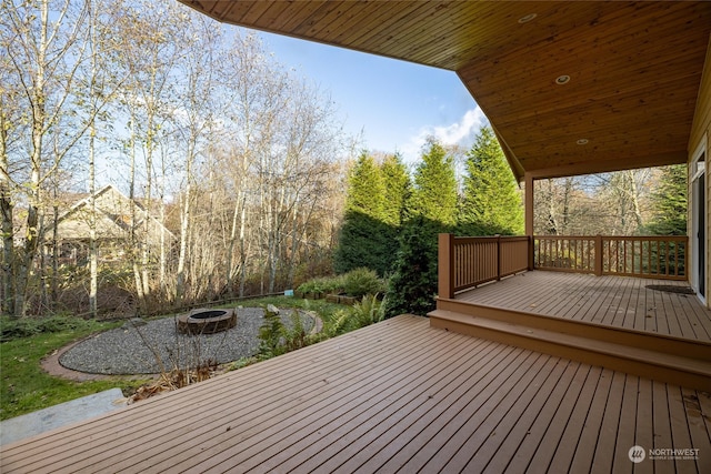 wooden deck featuring an outdoor fire pit