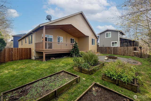 rear view of property with a deck and a yard