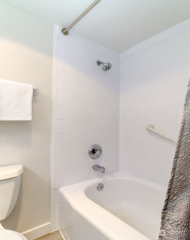 bathroom featuring toilet and shower / bath combo with shower curtain