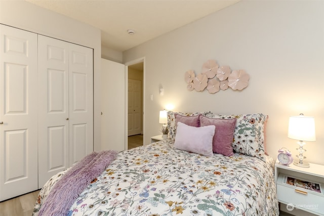 bedroom with hardwood / wood-style floors and a closet