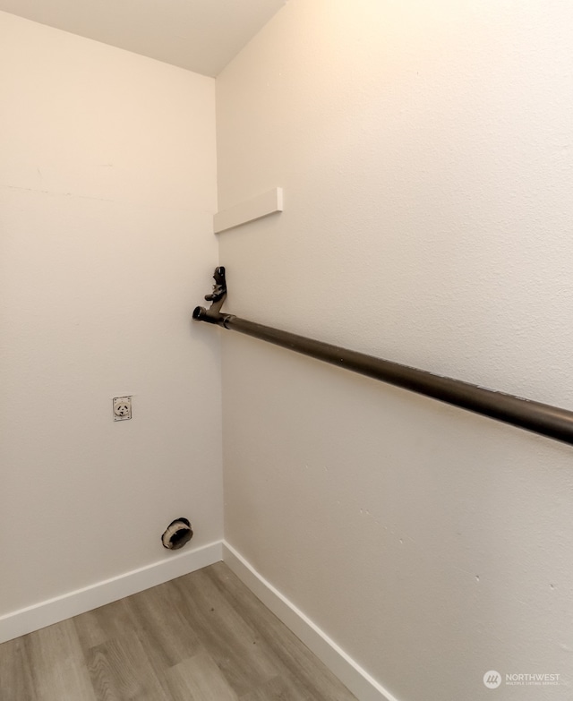 washroom with electric dryer hookup and hardwood / wood-style flooring