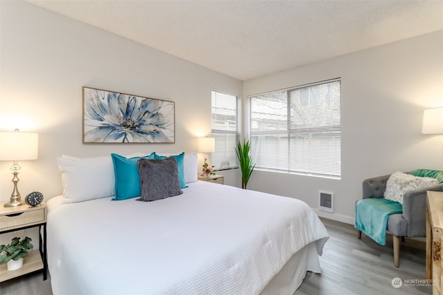 bedroom with hardwood / wood-style flooring