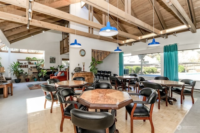 dining area featuring beam ceiling, light parquet flooring, high vaulted ceiling, and wood ceiling