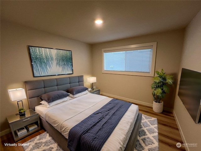 bedroom with hardwood / wood-style floors