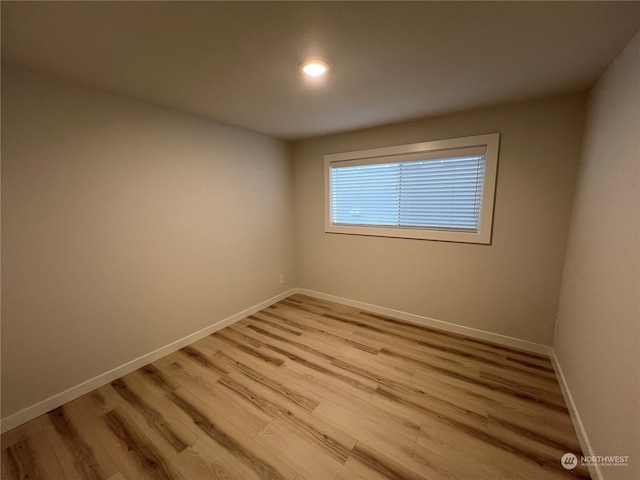 unfurnished room with light hardwood / wood-style floors