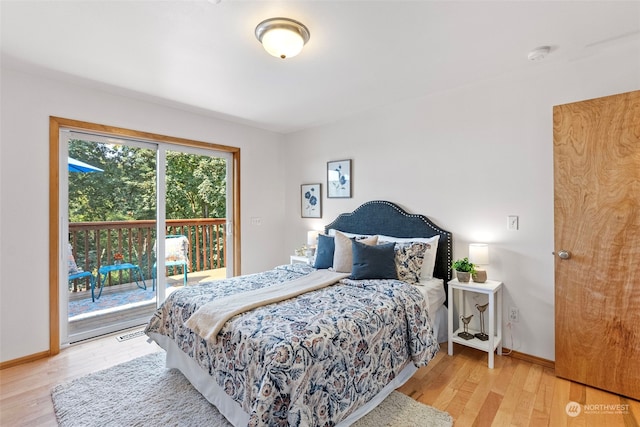 bedroom featuring access to exterior and light wood-type flooring