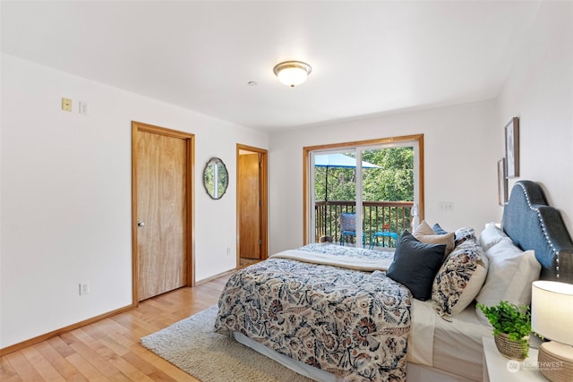 bedroom featuring light hardwood / wood-style floors and access to outside