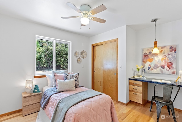 bedroom with ceiling fan, a closet, and light wood-type flooring