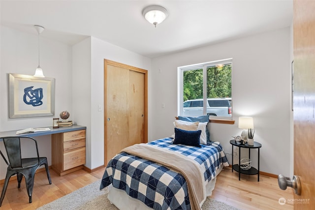 bedroom featuring light wood-type flooring and a closet