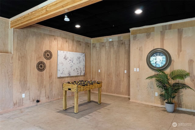 recreation room with wood walls