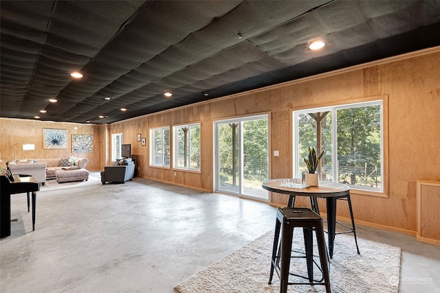 interior space with a healthy amount of sunlight and wooden walls