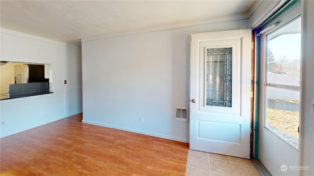 entryway featuring ornamental molding and light wood-type flooring