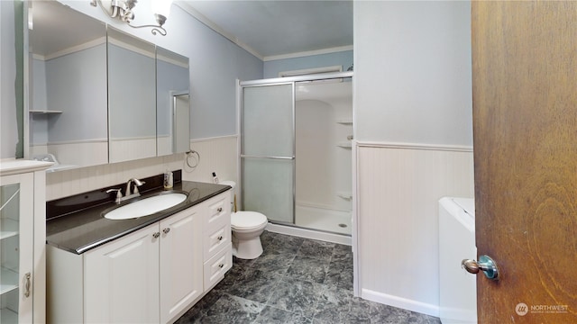 bathroom with crown molding, vanity, toilet, and an enclosed shower