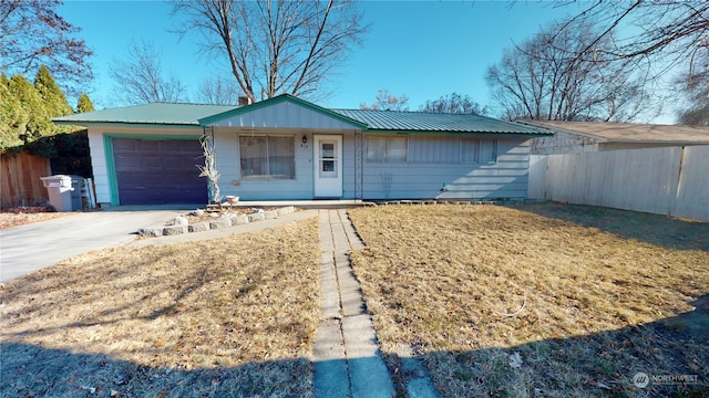 single story home featuring a garage and a front yard