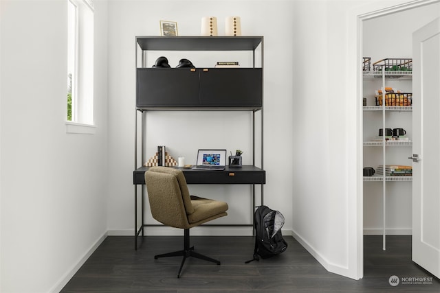 home office with dark hardwood / wood-style flooring