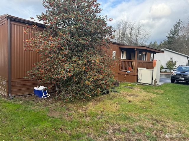 rear view of house featuring a lawn