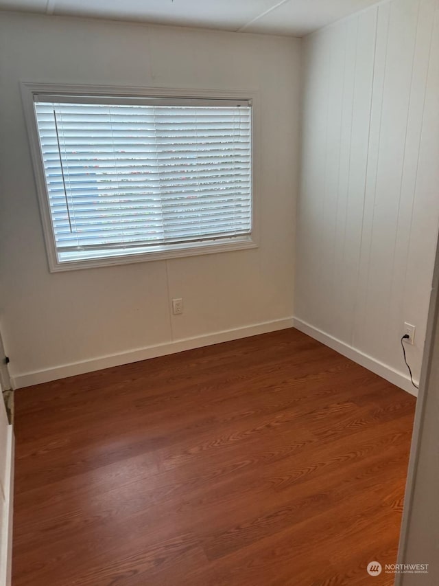 unfurnished room featuring dark hardwood / wood-style flooring