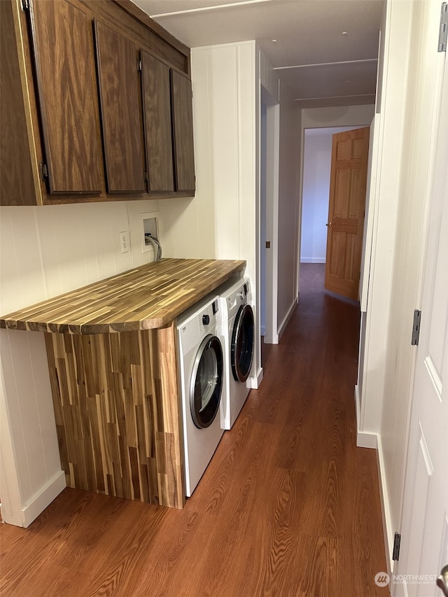 washroom with hardwood / wood-style floors, cabinets, and separate washer and dryer