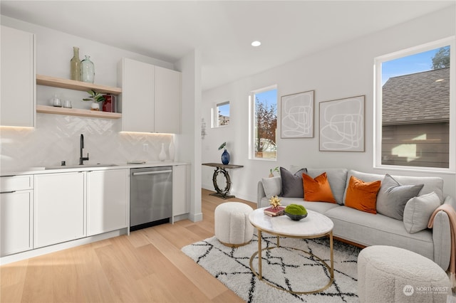 living room with wet bar and light wood-type flooring