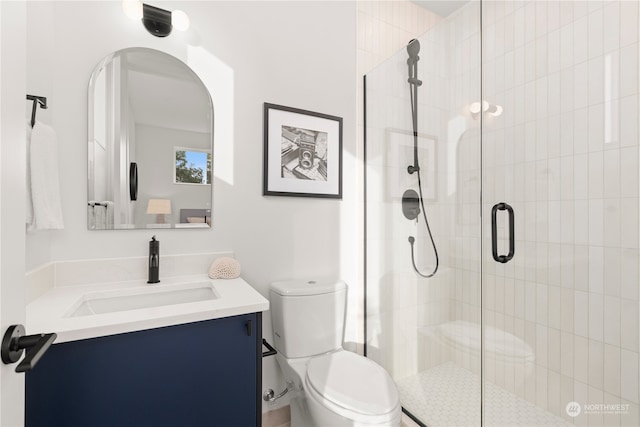 bathroom with vanity, toilet, and an enclosed shower