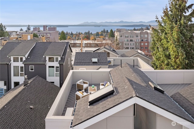 birds eye view of property with a water and mountain view