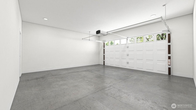 garage featuring recessed lighting, a garage door opener, and baseboards