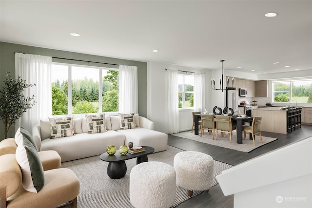 living room featuring dark hardwood / wood-style floors and an inviting chandelier