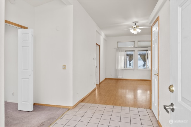 foyer with light hardwood / wood-style flooring and ceiling fan