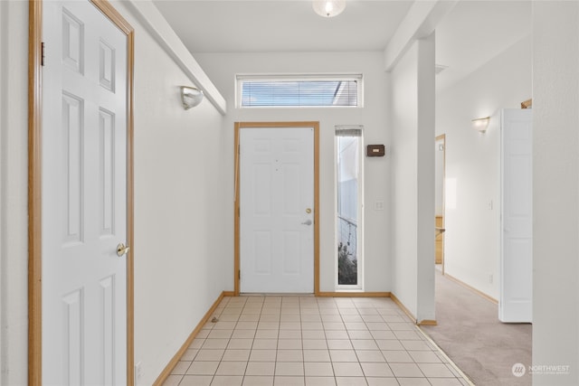 view of carpeted foyer entrance