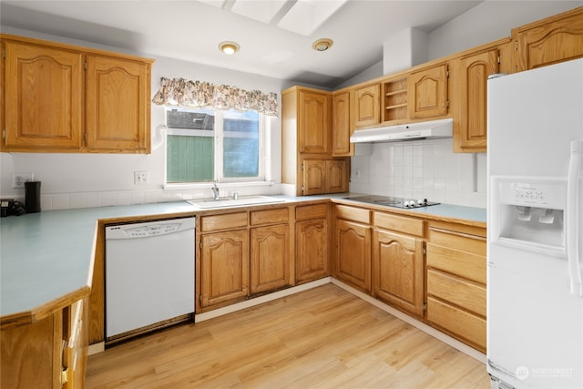 kitchen featuring vaulted ceiling, sink, light hardwood / wood-style floors, and white appliances