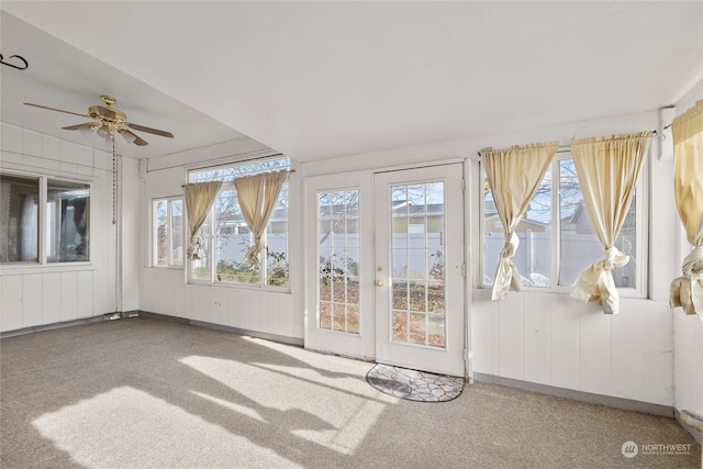 unfurnished sunroom with plenty of natural light and ceiling fan