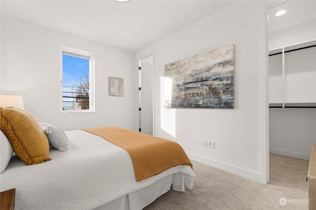 bedroom with recessed lighting, baseboards, a closet, and light colored carpet