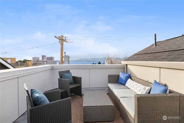 view of patio / terrace with a balcony and a water view