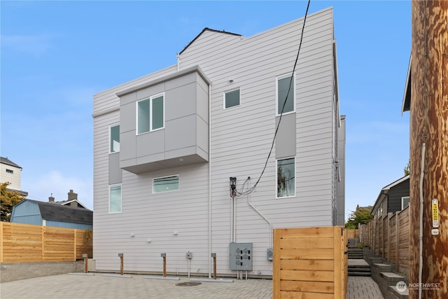 back of property with a patio and fence