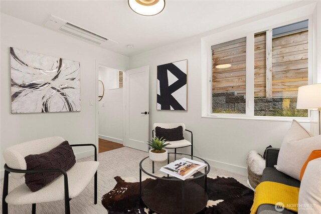 living area with wood finished floors and baseboards