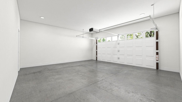 garage featuring recessed lighting, baseboards, and a garage door opener